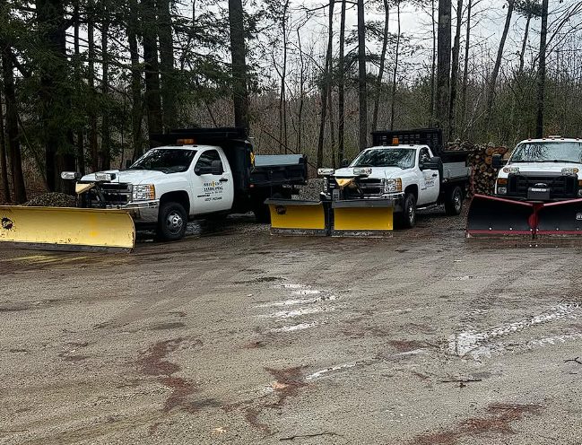 Snow plow clearing a driveway in Kennebunk, Maine